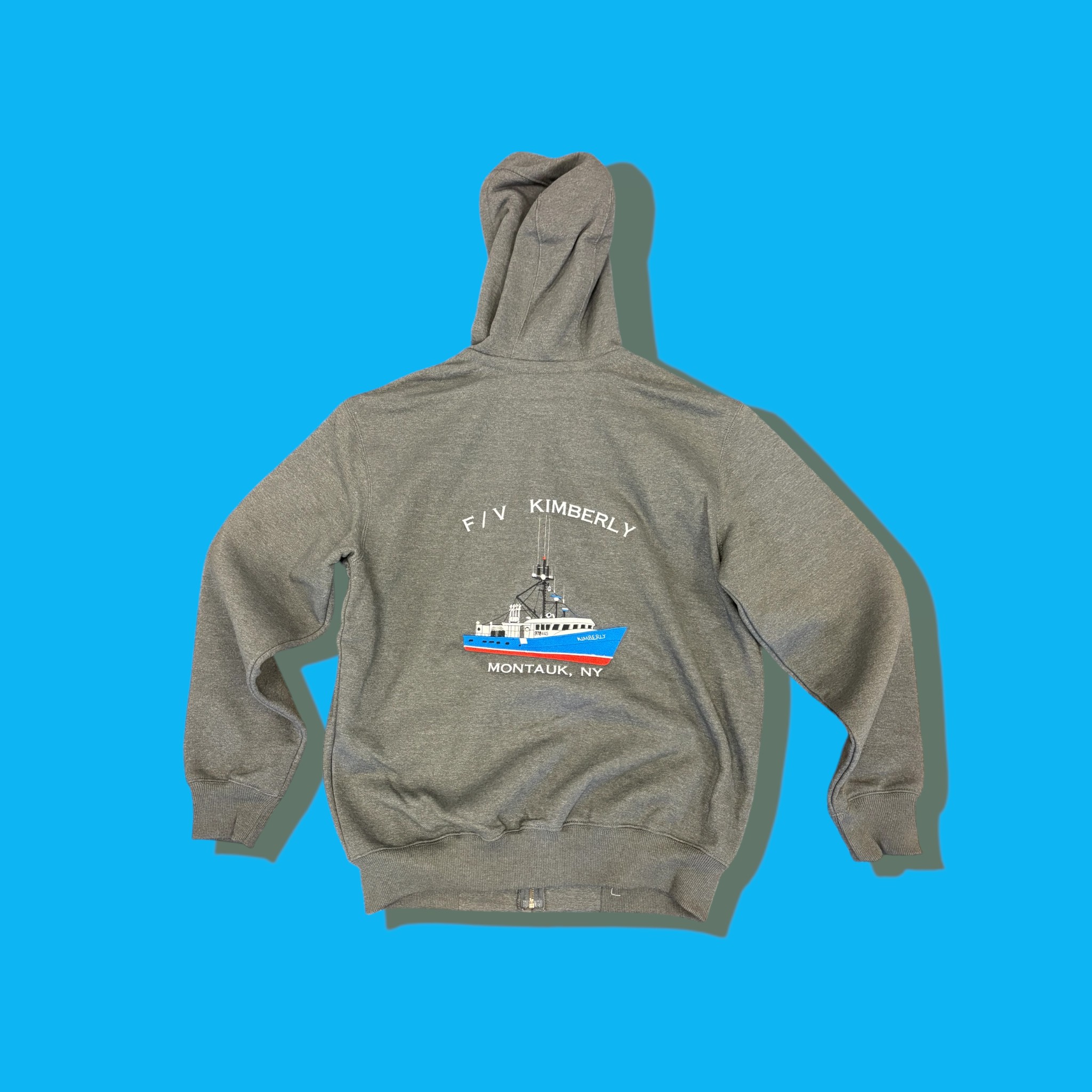 Grey full-zip hoodie with detailed multi-color full-back embroidery of a fishing trawler