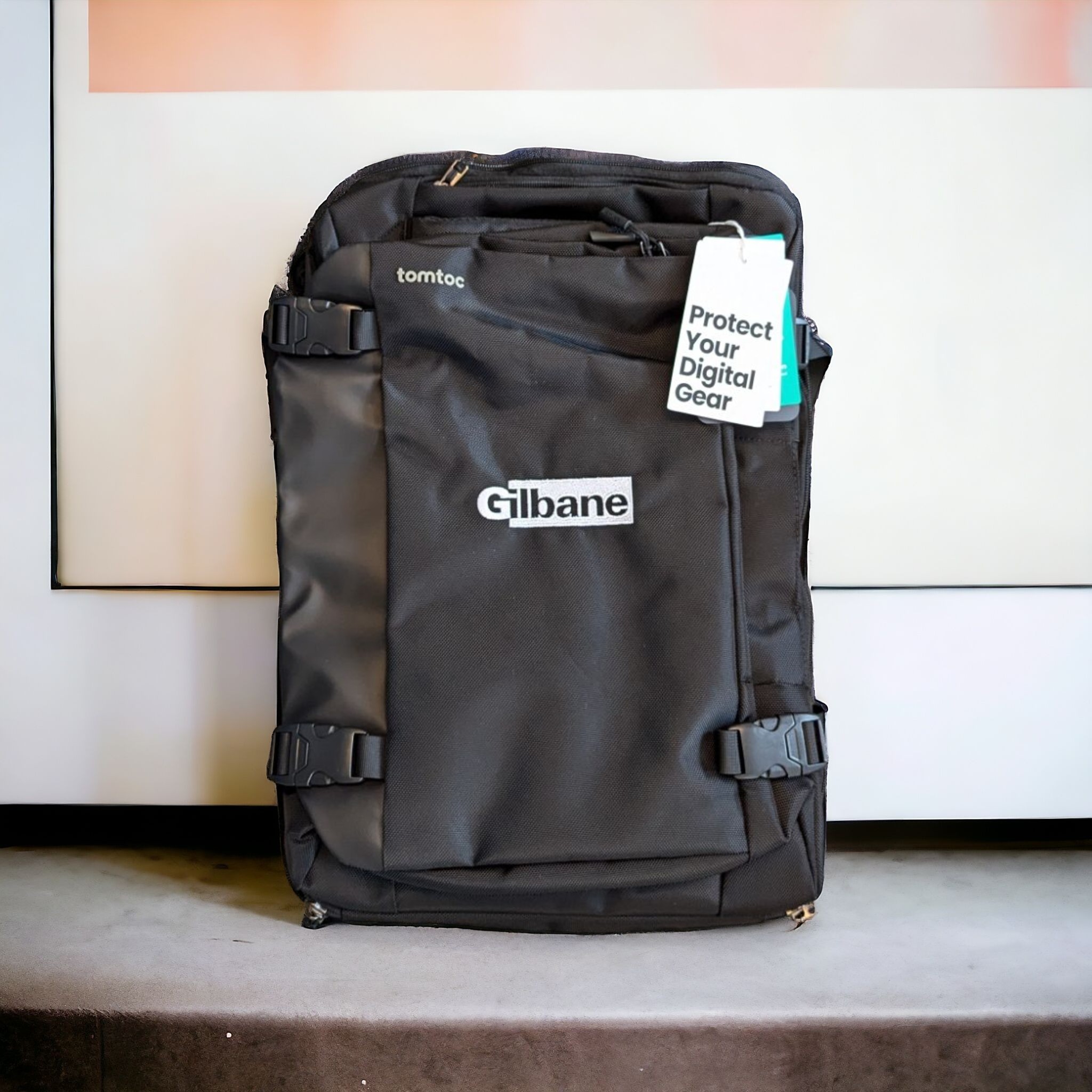 Gilbane logo custom embroidered on a black travel backpack