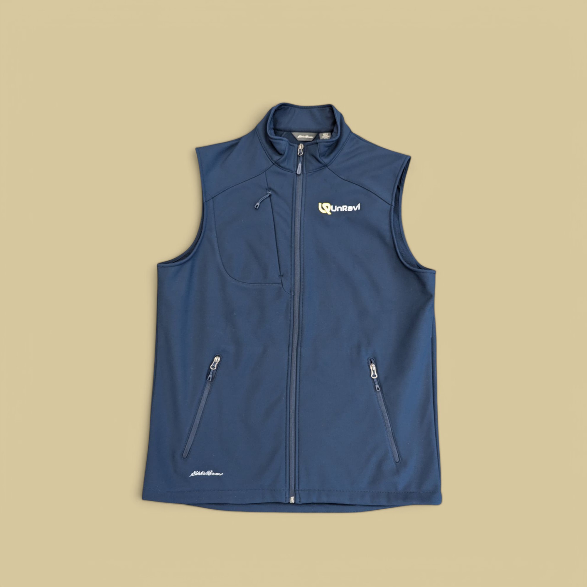 Unravl logo custom embroidered on a navy blue Eddie Bauer puffer vest