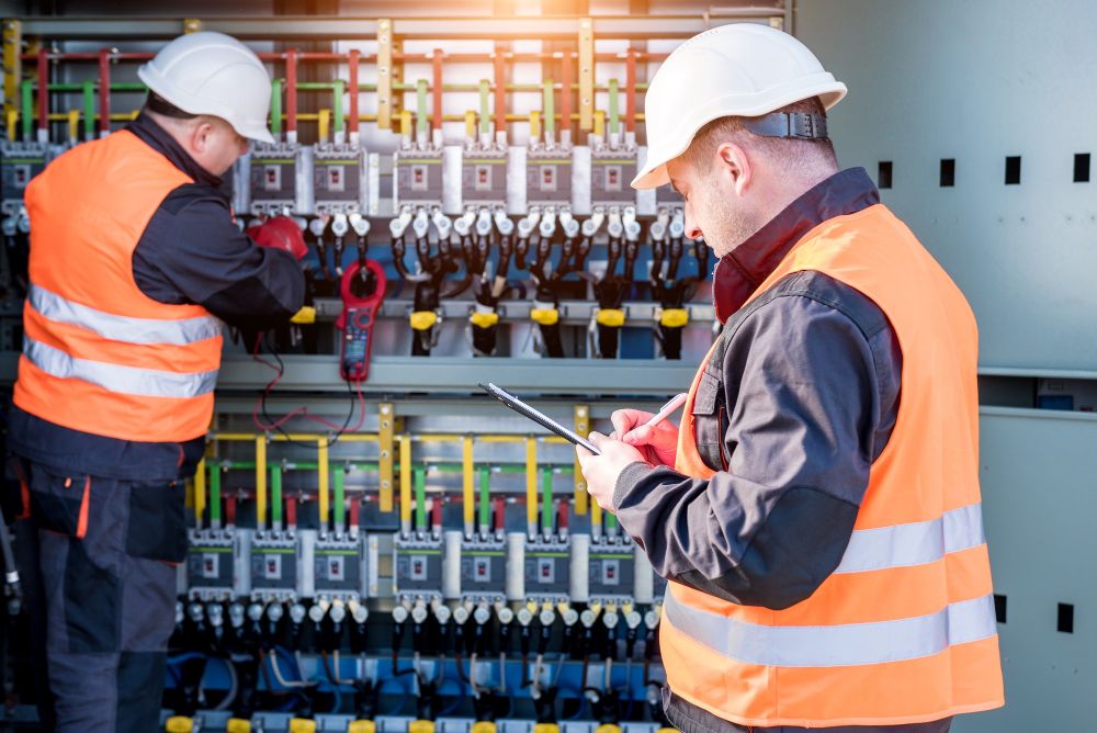 Electricians wearing uniform and working